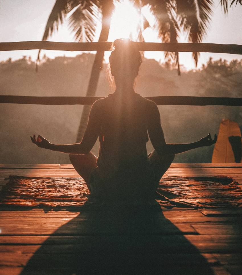woman doing yoga meditation on brown parquet flooring